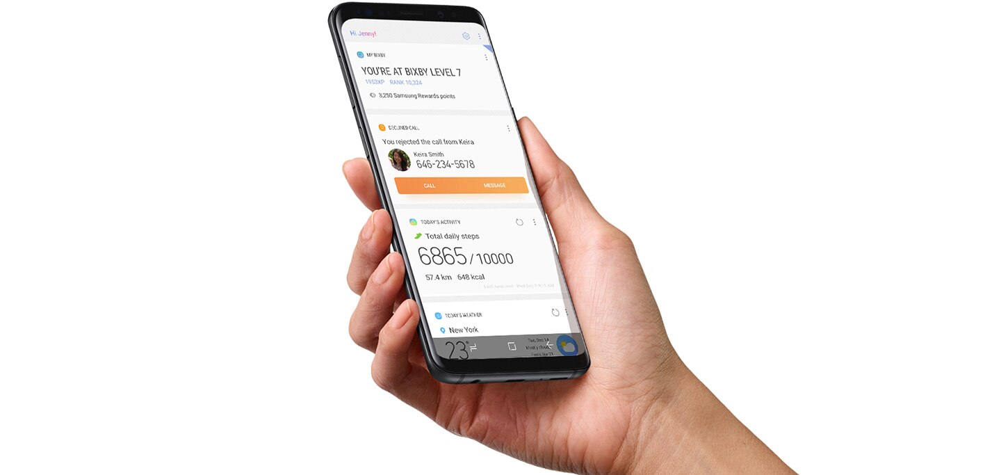 Image d'une main droite tenant un Galaxy S9 Midnight Black avec l'accueil de l'application Bixby en cours d'exécution.