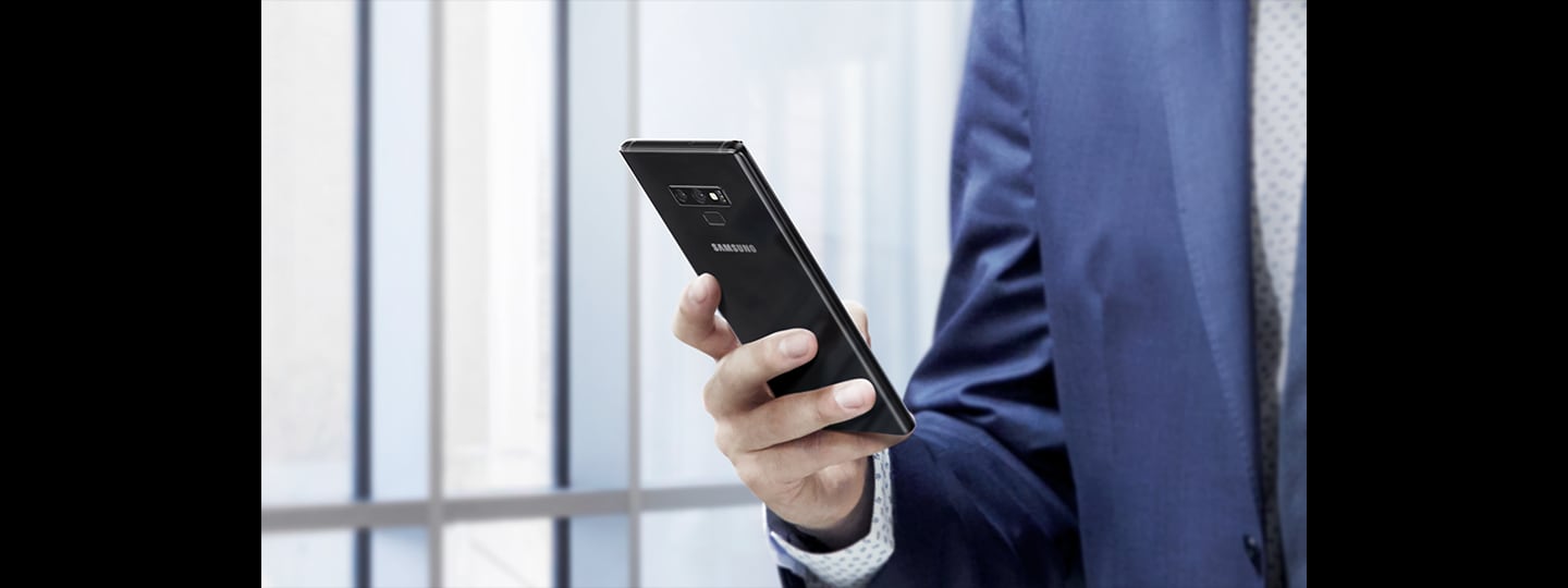 Vaizdas su žmogumi, laikančiu „Galaxy Note9“ dieną