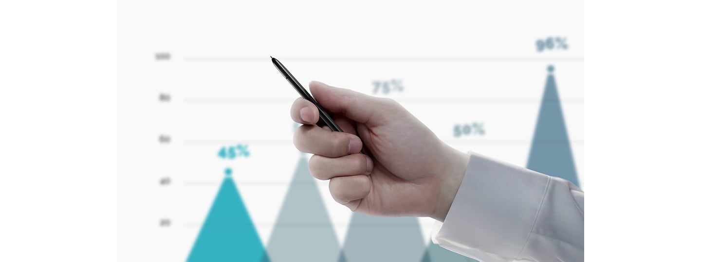 Simulerad bild av en person som håller S Pen med en presentation som visar ett linjediagram i bakgrunden. När personen klickar på S Pen-knappen byter presentationen bild och visar ett annat diagram.