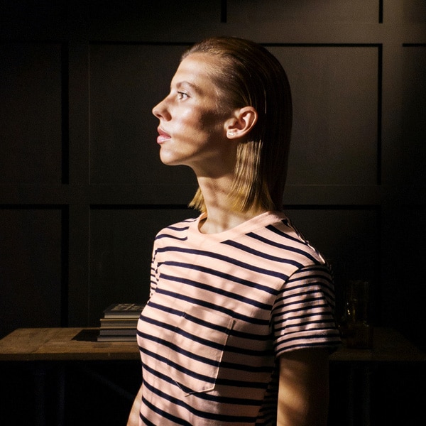A photo taken by Galaxy Note9 of a woman wearing a striped shirt and covered in striped shadows